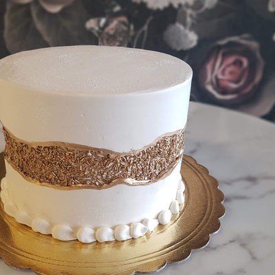 Discover timeless elegance with our Metallic Fault Line Cake, a perfect choice for anniversaries, elopements, and milestone birthdays. Adorned with striking gold, silver, or rose gold accents, this customizable masterpiece is tailored for any special occasion. The modern and versatile design features a buttercream fault line, adding a unique touch to your celebration. Make every moment memorable with a cake that transcends style and taste. Order yours today and elevate your special occasions to new heights