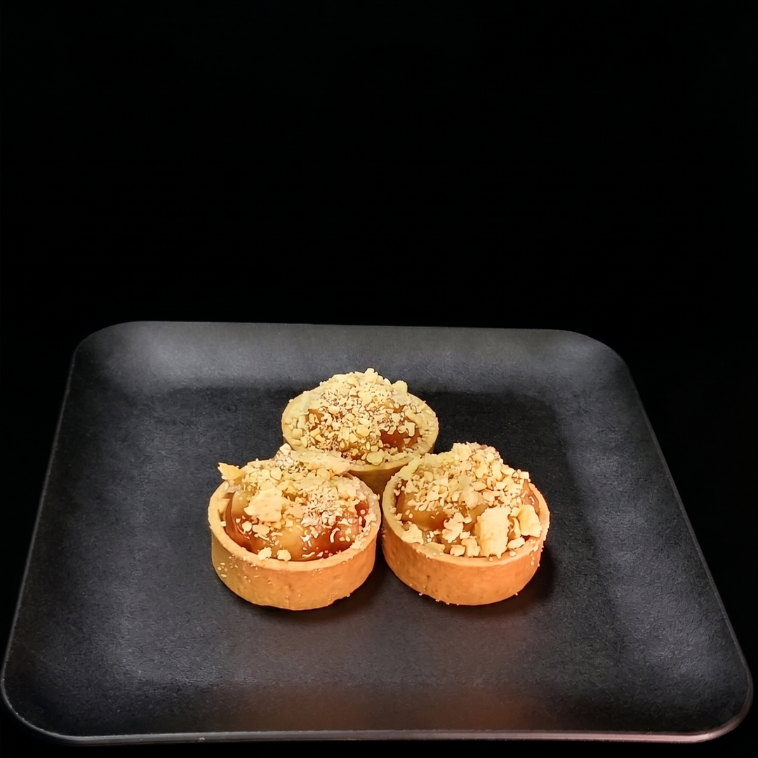 Apple and blueberry streusel tart featuring cinnamon-spiced apples, sweet blueberries, and a golden buttery crumble topping in a handcrafted pastry shell.