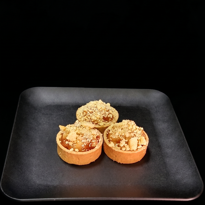 Apple and blueberry streusel tart featuring cinnamon-spiced apples, sweet blueberries, and a golden buttery crumble topping in a handcrafted pastry shell.