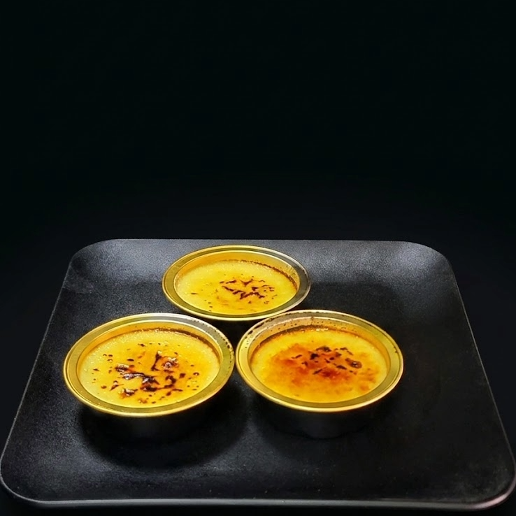 Classic crème brûlée with silky vanilla bean custard and a crisp caramelized sugar topping, handcrafted by a luxury bakery.