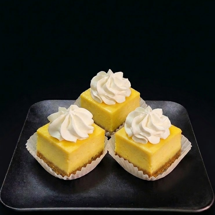 Mini cheesecake bites with creamy cheesecake filling and buttery graham cracker crust, handcrafted for dessert tables and special events.