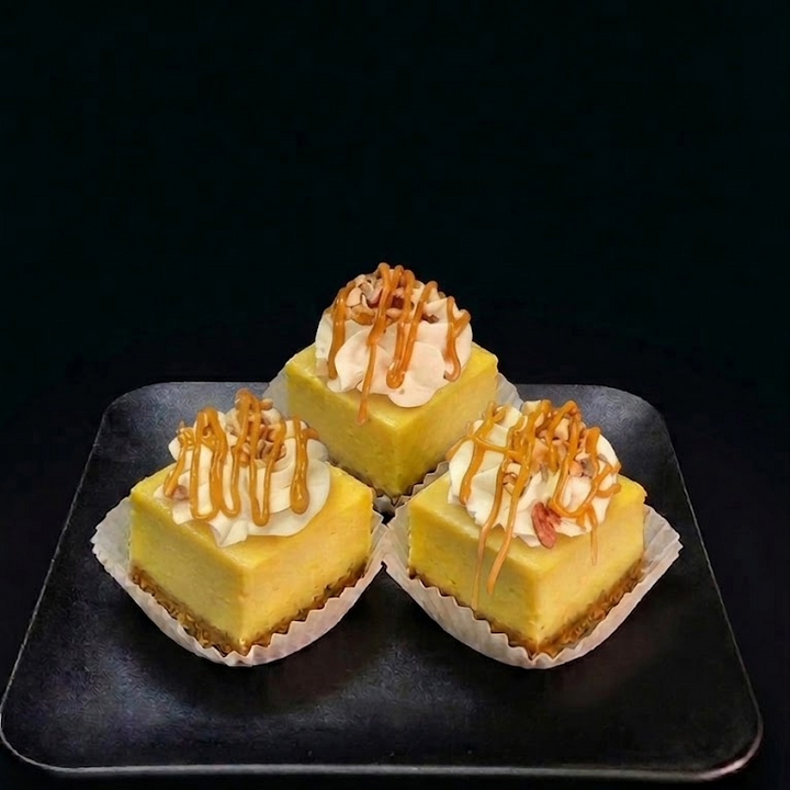 turtle cheesecake. new york cheesecake topped with caramel mousse, pecans and caramel drizzle