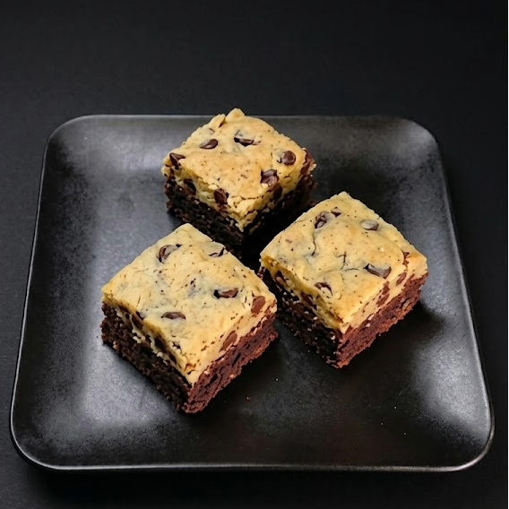 Brookie bites featuring layers of fudgy brownie and chocolate chip cookie baked into bite-sized dessert squares.