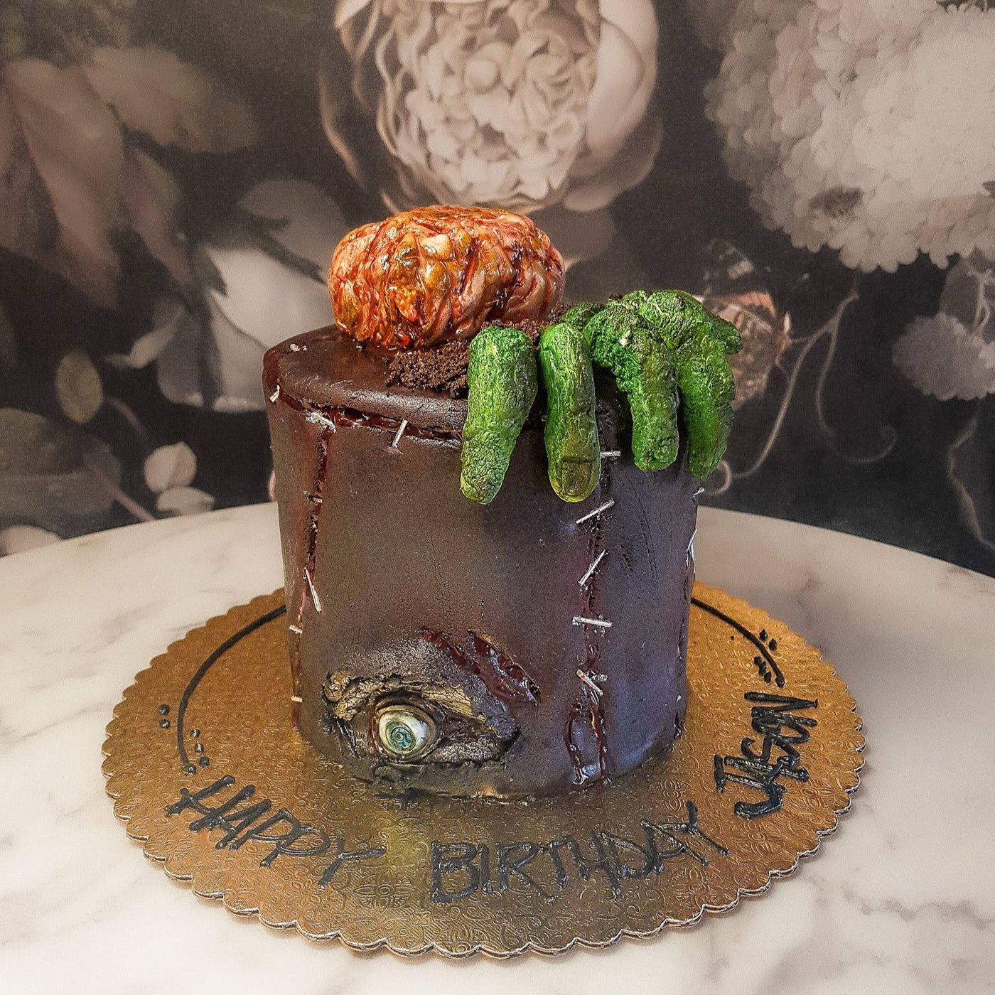 Although visually rotting, this fondant covered cake is moist and delicious on the inside. This infected character is bound to create a horrifying centerpiece- perfect for your October celebration!