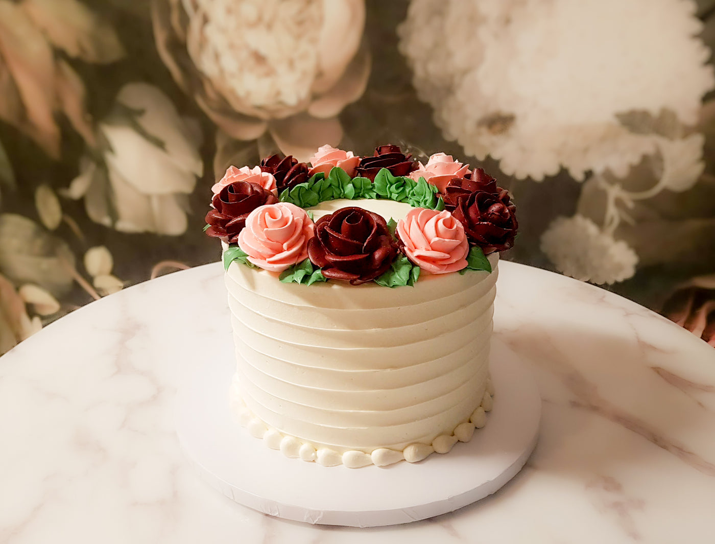 Large roses arranged in a wreath on your cake to create a rustic bohemian vibe- both simple and elegant.  A great centerpiece for your party.  Customize: Flower colors, size, flavor