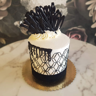 These patterns give cakes a solid structure look providing space for our designers and decorators to play around with more fun, unpredictable strokes. tie that all together with a nice strong black band at the bottom, and voila! 