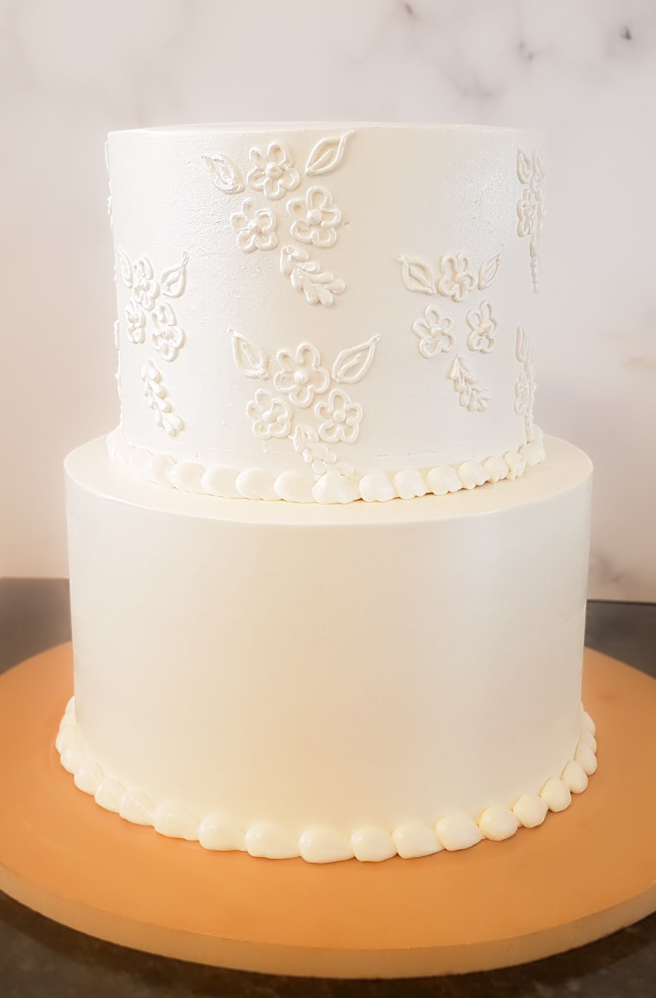Tiny flowers piped around your cake to show a quiet, simplistic elegance for your special affair. This cake is perfect for baptisms, communions, weddings and intimate gatherings.