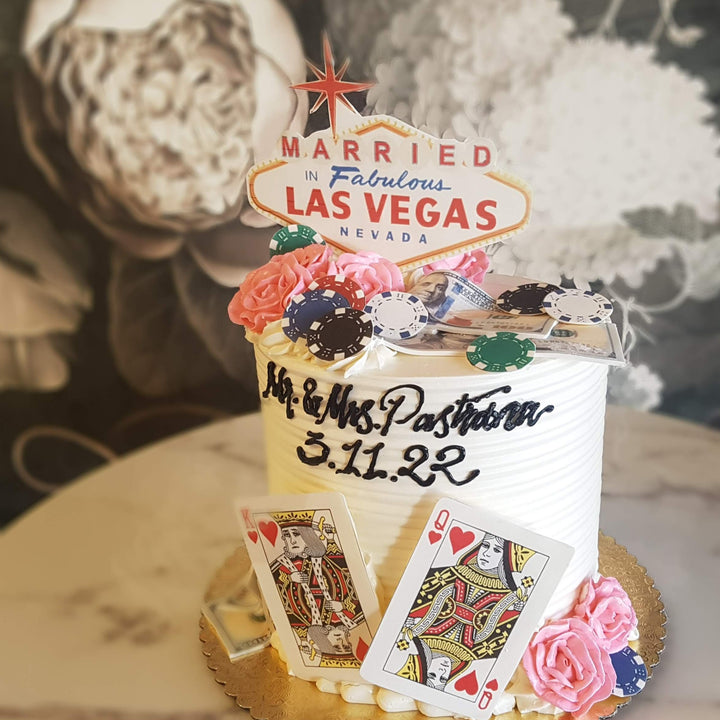 Vegas sign, poker chips, kind and queen of hearts, elopement cake, dollar bills