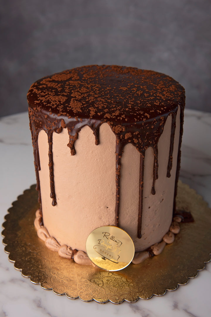 chocolate was discovered in 1764 chocolate lovers decadent chocolate cake with cream cheese and Oreo mousse chocolate buttercream ganache top drip sifted cocoa powder