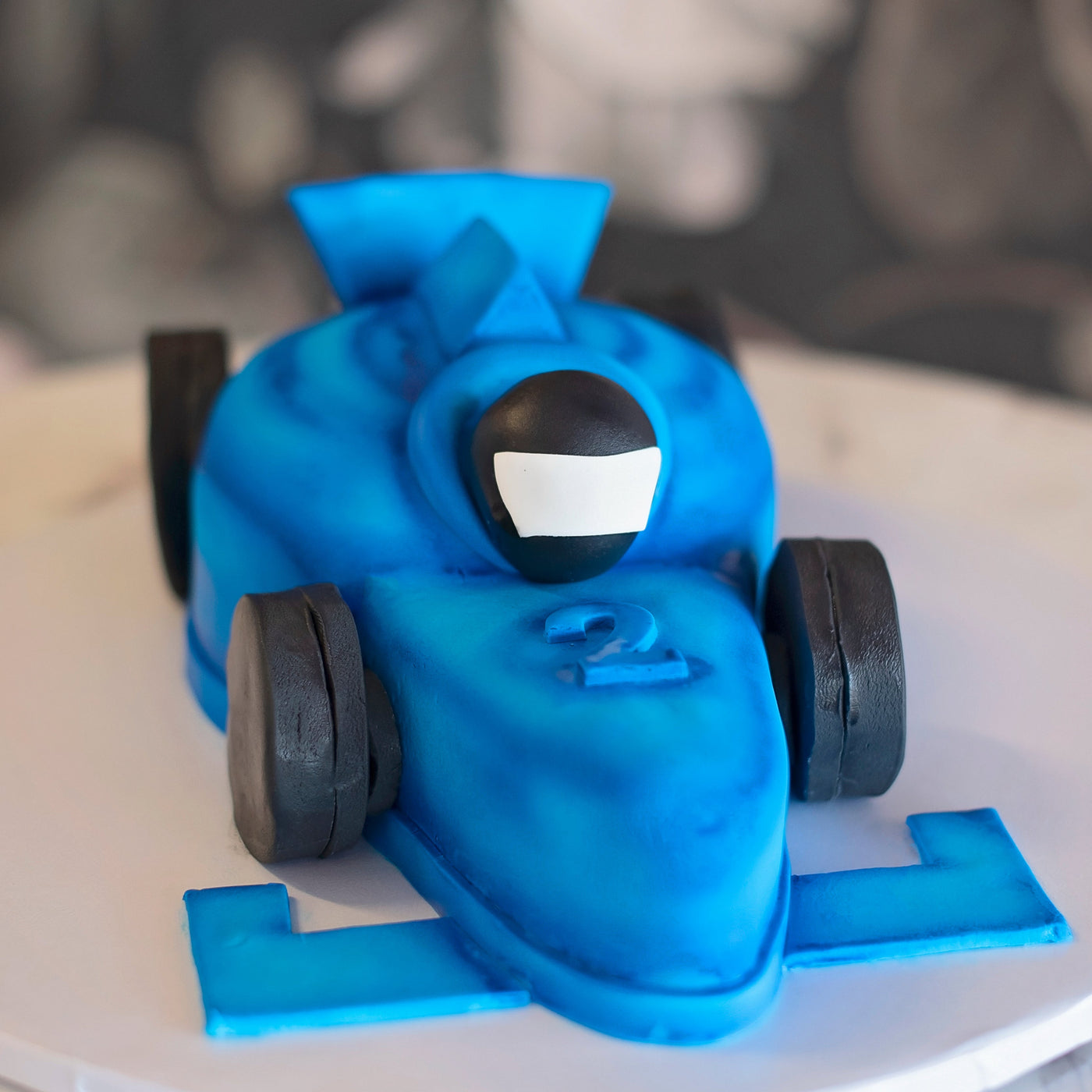 Your little speedy car driver and tires will be made out of fondant, but the rest of your cake will still be covered by our buttercream then a thin layer of fondant on top to create a matte finish.