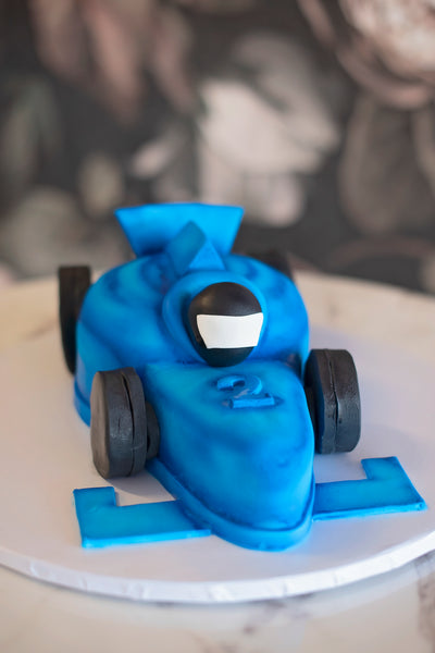 Your little speedy car driver and tires will be made out of fondant, but the rest of your cake will still be covered by our buttercream then a thin layer of fondant on top to create a matte finish.